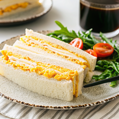 The Ultimate Guide to the Japanese Egg Sandwich – Why It’s Taking Over the World 6 Japanese egg sandwich on a plate with salad and coffee